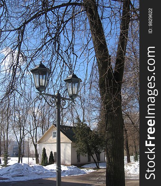 Old flashlight in Moscow park at winter day