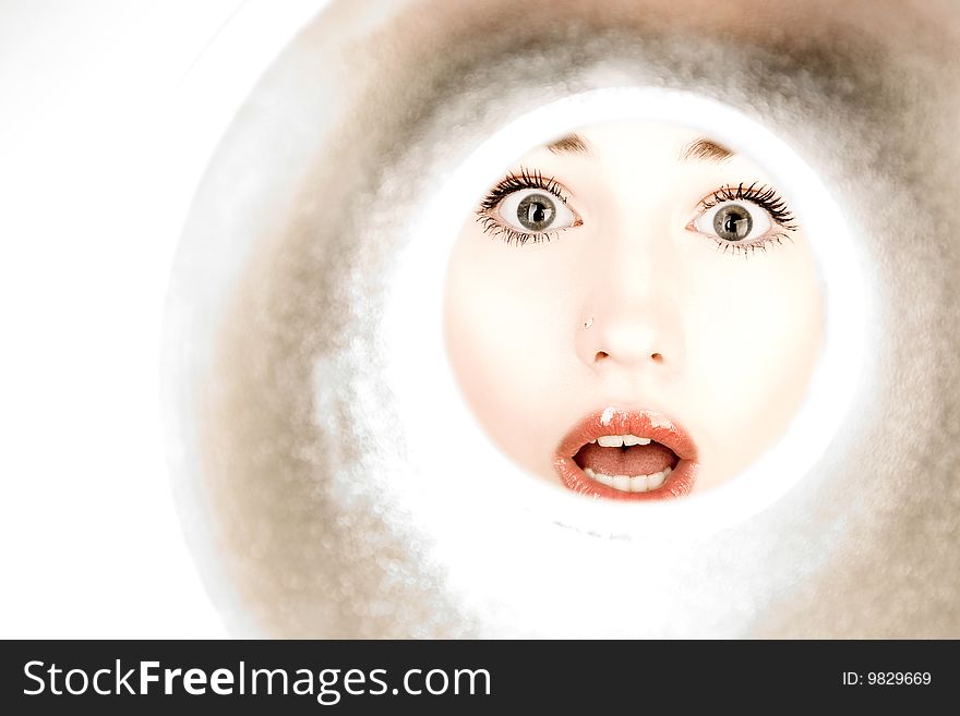 Woman looks through a pipe