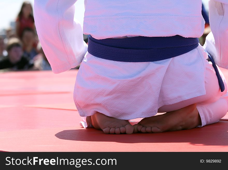 Judo fighter sitting on the ground
