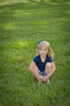 Little Girl Sitting In Grass Royalty Free Stock Photography Little Girl Sitting In Grass Royalty Free Stock Photography