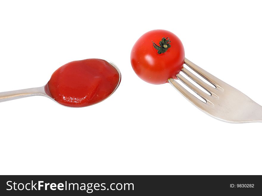 Detail of tomato with spoon and fork. Detail of tomato with spoon and fork