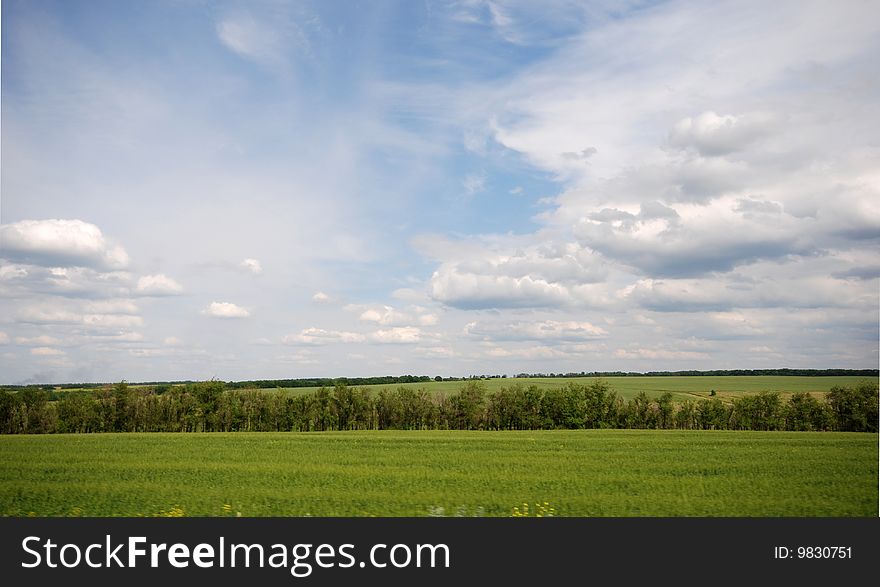 A panoramic view of a meadow and sky. A panoramic view of a meadow and sky