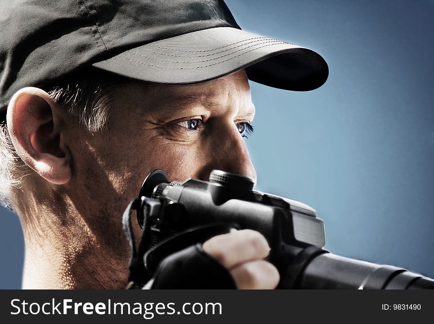 Photographer with cap and camera on blue background. Photographer with cap and camera on blue background