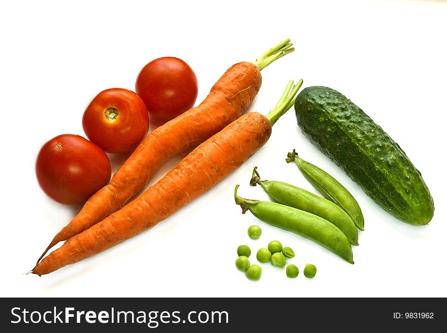 Fresh vegetables,  red carrots and tomatoes, green cucumber