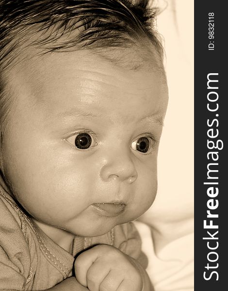 Close-up soft sepia toned portrait of likable baby. Close-up soft sepia toned portrait of likable baby