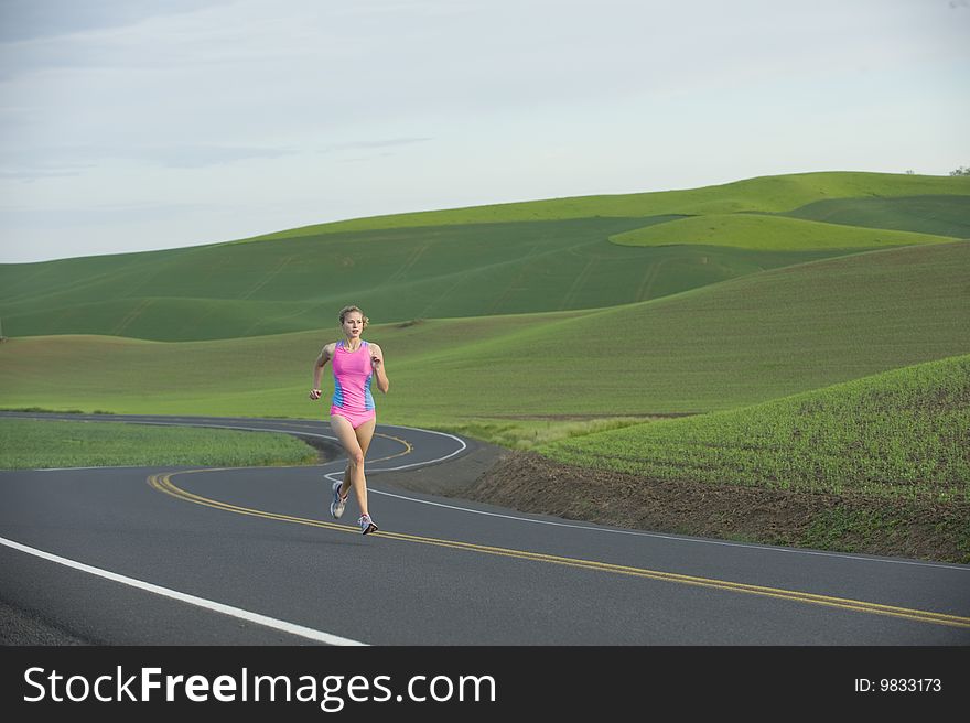 Runner on rural road in farm land