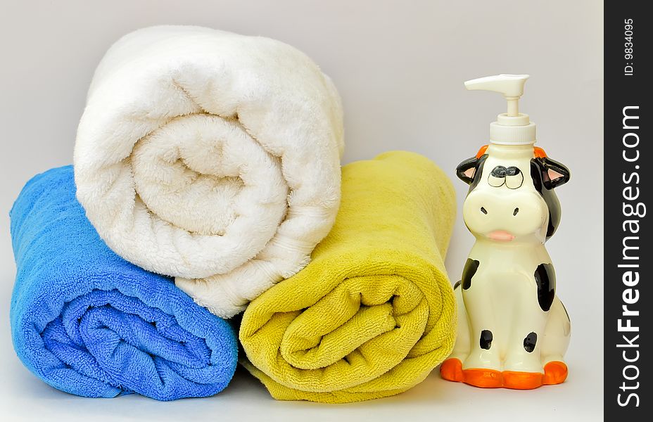 Pile of towels with a liquid soap dispenser