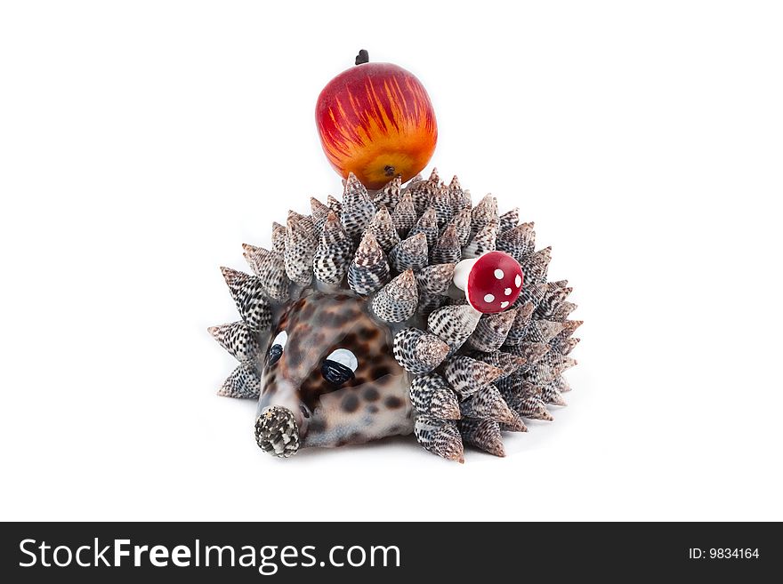 Hedgehog with apple on spines isolated on white background. Hedgehog with apple on spines isolated on white background