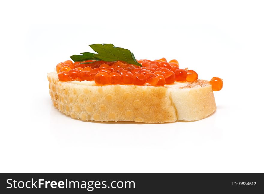 Red caviar on white bread, parsley on top. Red caviar on white bread, parsley on top