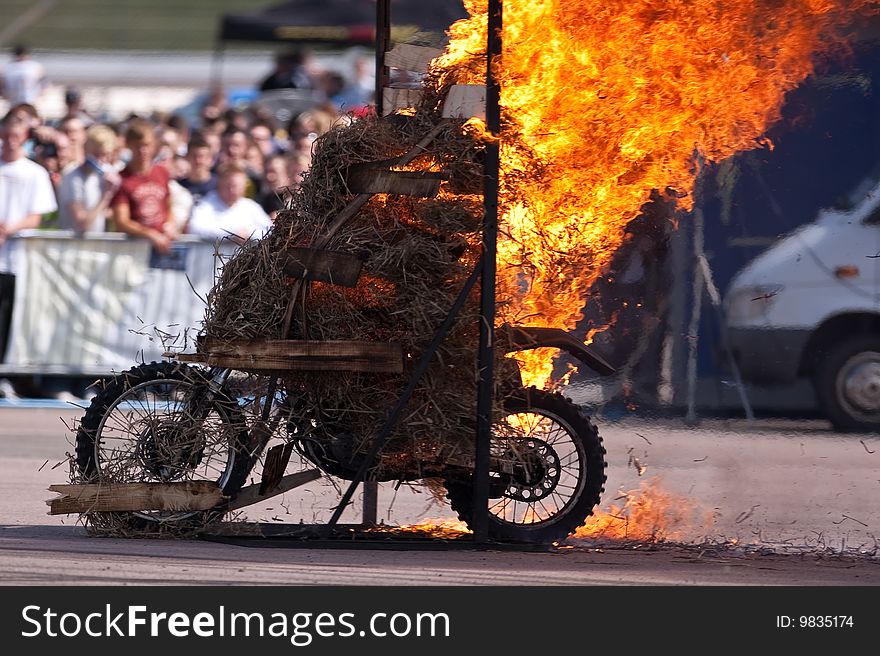 Stunt rider riding through a wall of flames. Stunt rider riding through a wall of flames