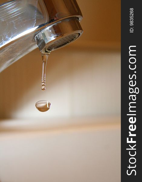 Droplet falling from a faucet.