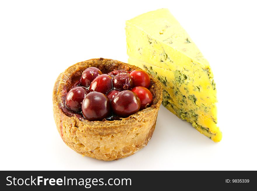 Single pork with cranberries on the top with a slice of blue cheese, with clipping path on a white background. Single pork with cranberries on the top with a slice of blue cheese, with clipping path on a white background