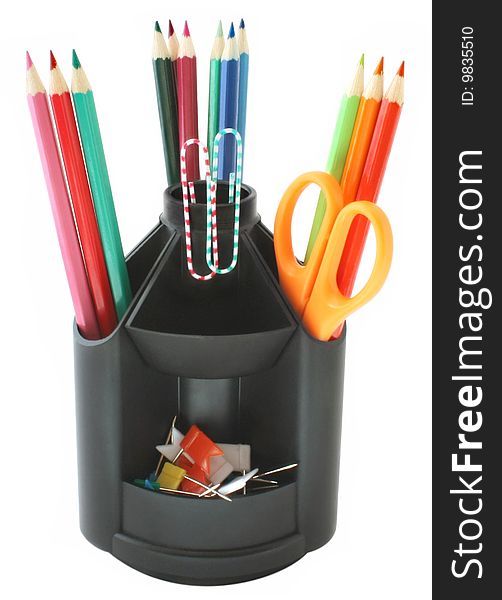 Pencils in a pencil holder on the white background. Pencils in a pencil holder on the white background