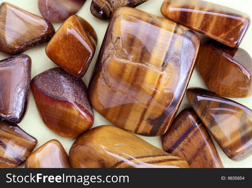 A group of small stripy brown stones. A group of small stripy brown stones