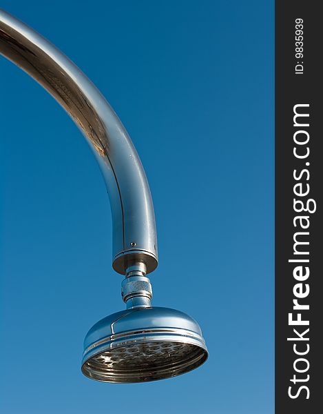 Outside shower head against a blue sky on beach resort by sea. Outside shower head against a blue sky on beach resort by sea