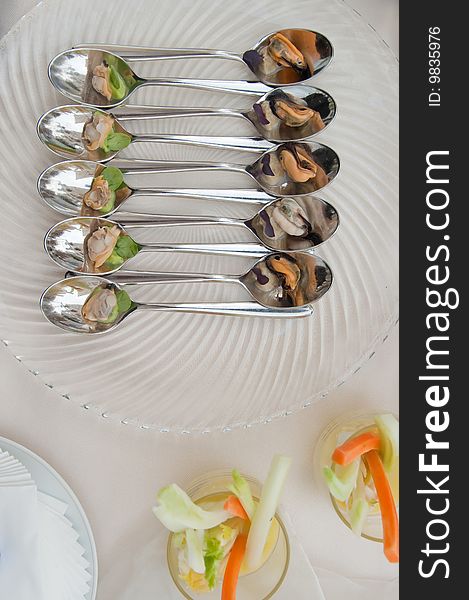 Mussel and arranged in a very stilish composition on a spoon. Mussel and arranged in a very stilish composition on a spoon