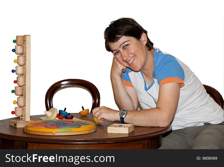 Smiling mid age woman plays with wooden toys isolated. Smiling mid age woman plays with wooden toys isolated