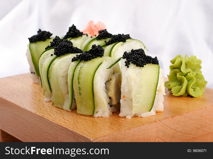 Shushi and black caviar on wood plate