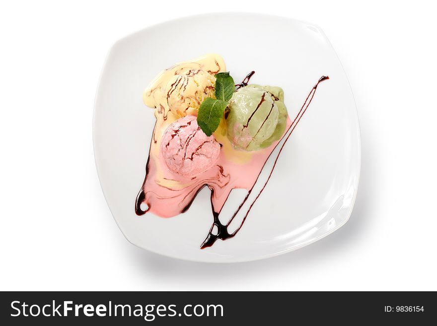 Colored ice cream on a plate on white background. Top view. Colored ice cream on a plate on white background. Top view