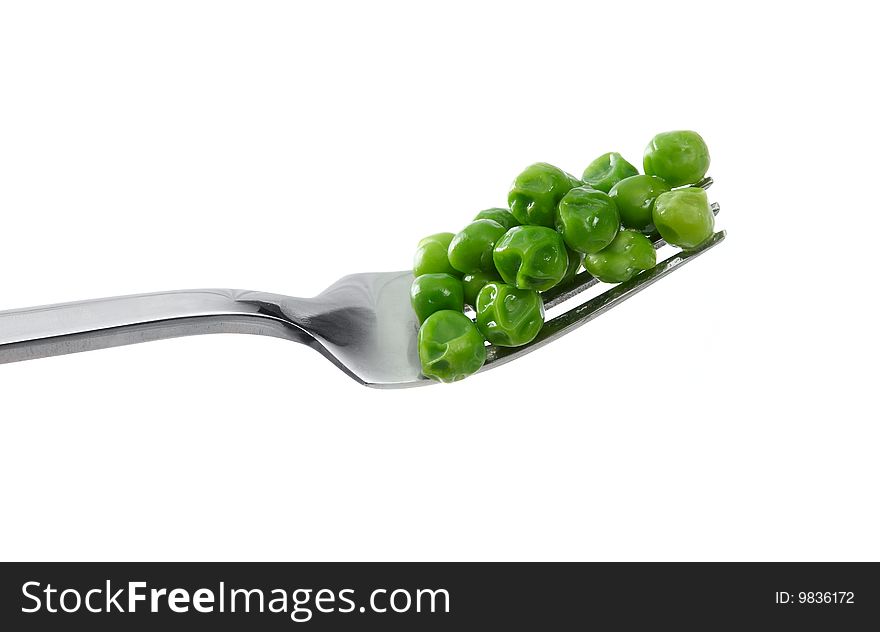 Peas on a fork on a white background. Peas on a fork on a white background