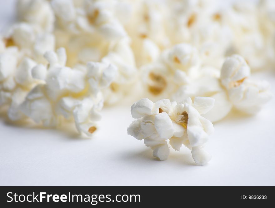 Popped popcorn on white background