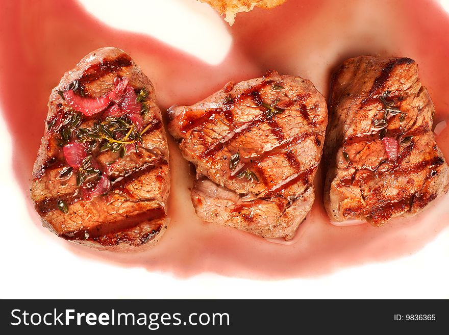 Grilled meat with sauce. Closeup
