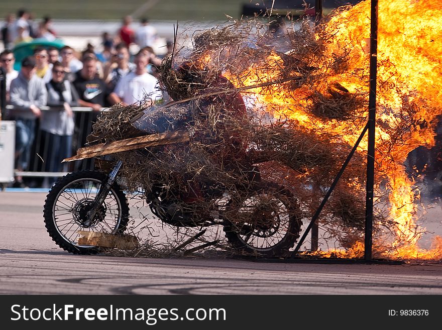 Stunt rider riding through a wall of flames. Stunt rider riding through a wall of flames