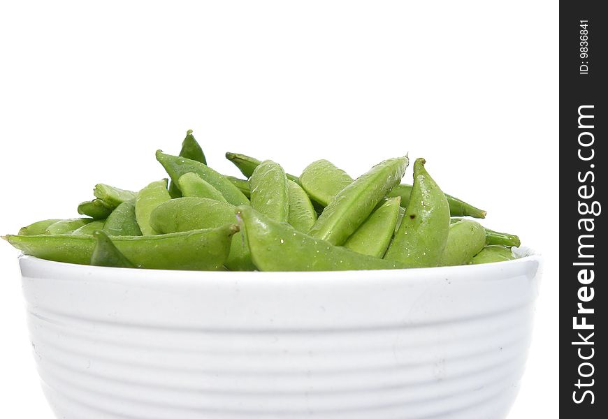 Fresh Green Beans in a white bowl set against a bright white background