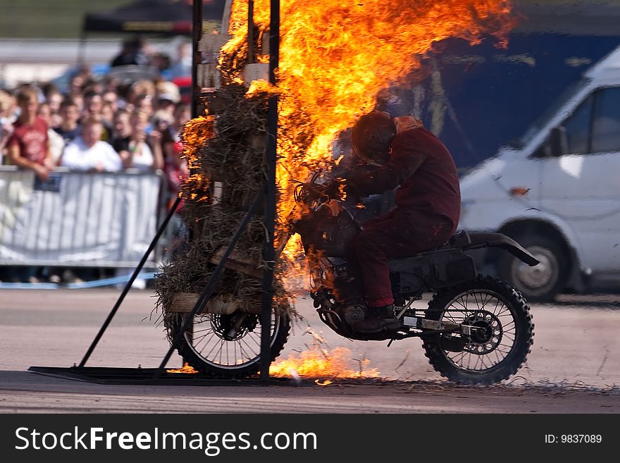 Stunt rider riding through a wall of flames. Stunt rider riding through a wall of flames