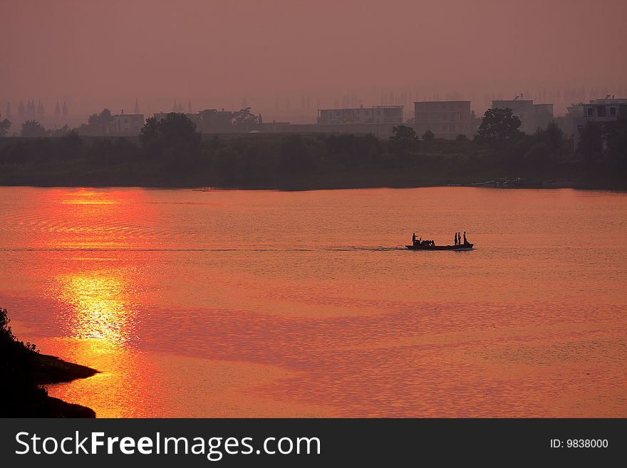 The river is golden at sunset. The river is golden at sunset