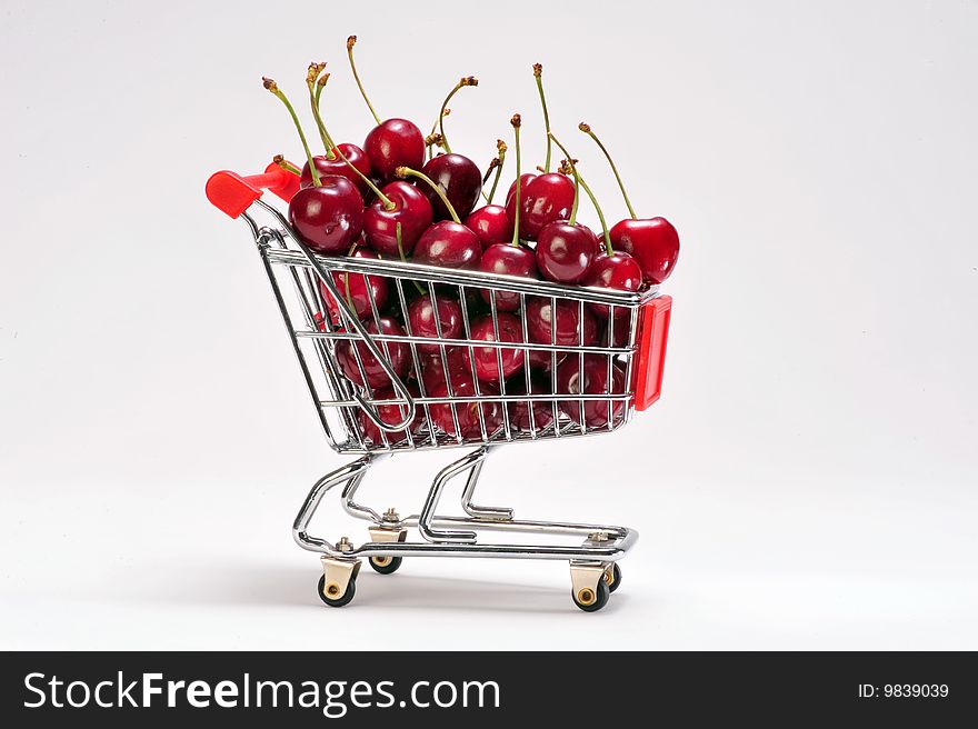 Cherries in a grocery cart.