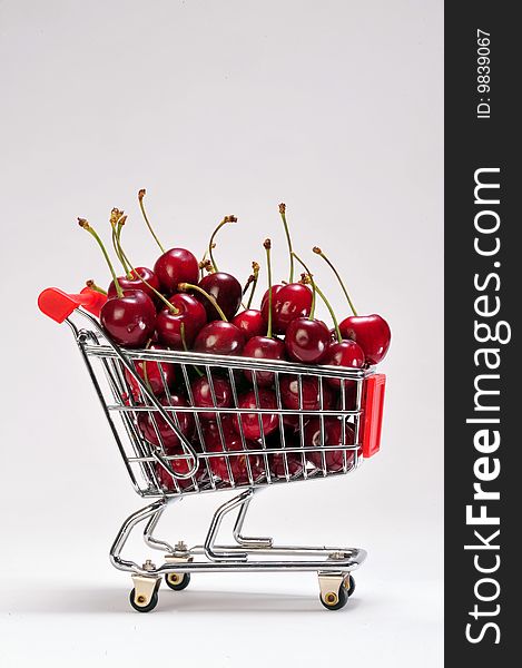 Cherries in a grocery cart.