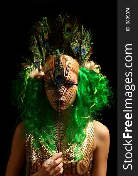 Girl-peacock in gold dress with green hairs