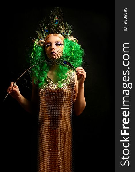 Girl-peacock in gold dress with green hairs