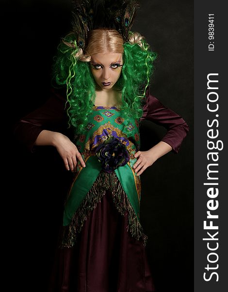 Girl-peacock in dress with green hairs. Girl-peacock in dress with green hairs