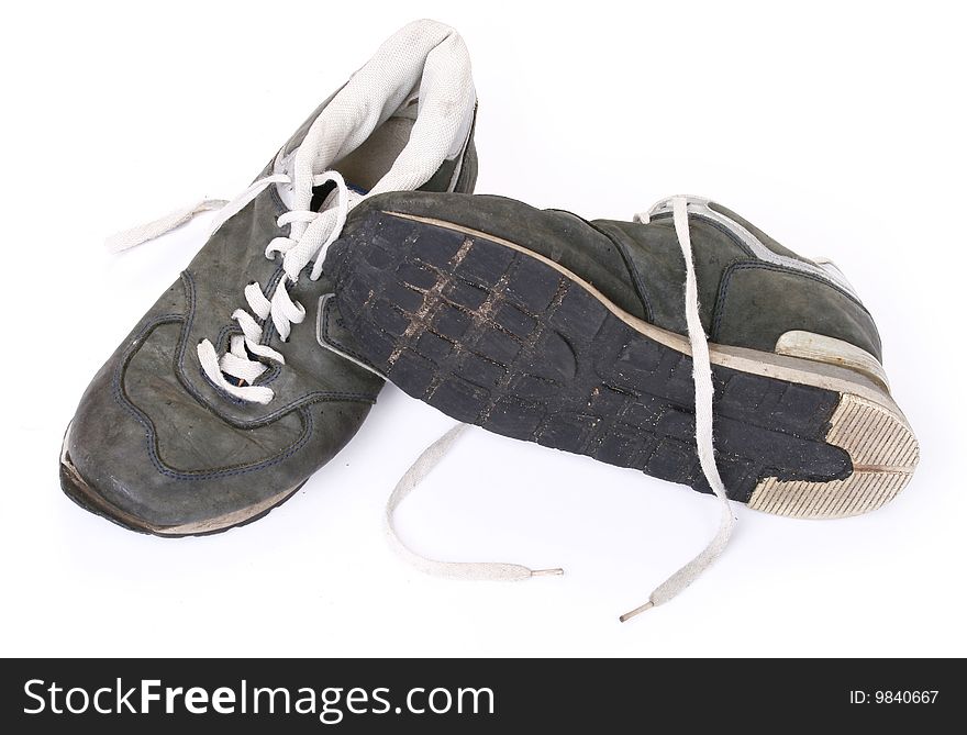 Old grungy Running Shoes isolated on white background