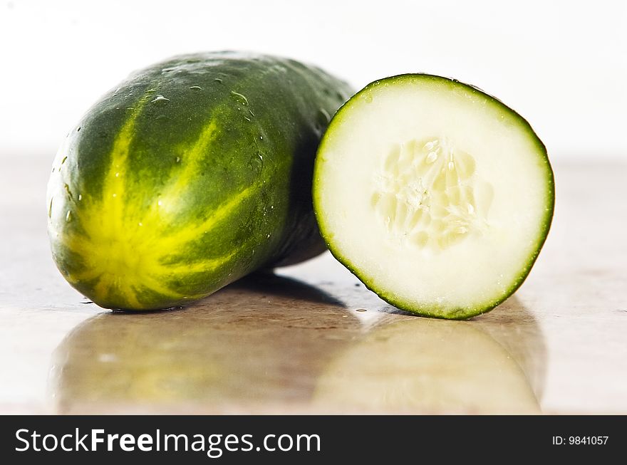 Green cucumber on a stone counter