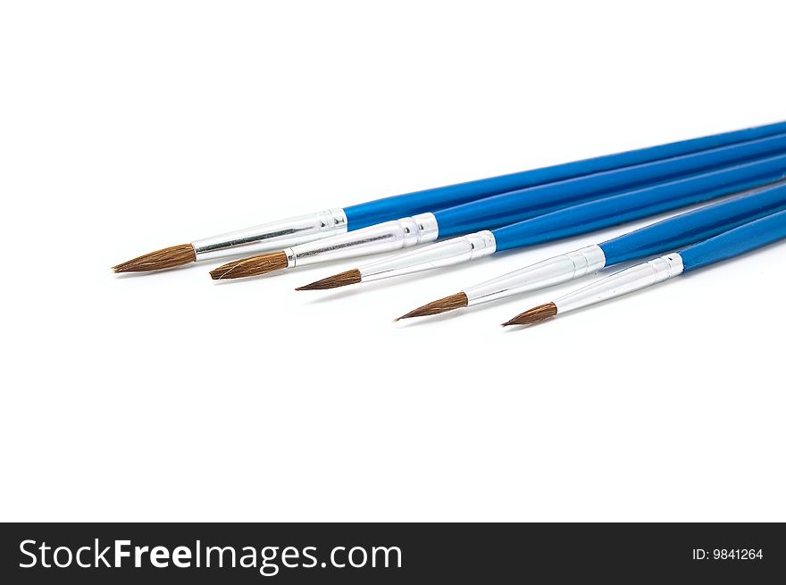 Five paintbrushes on a white background. Close-up. Five paintbrushes on a white background. Close-up.