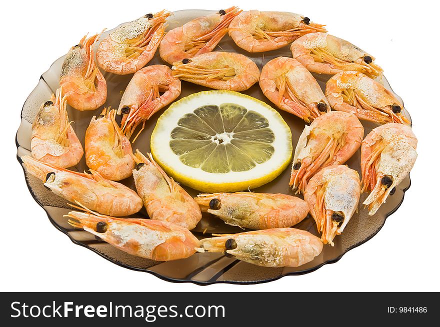 Plate with the sea Kamchatka shrimps stacked on a circle and a lemon