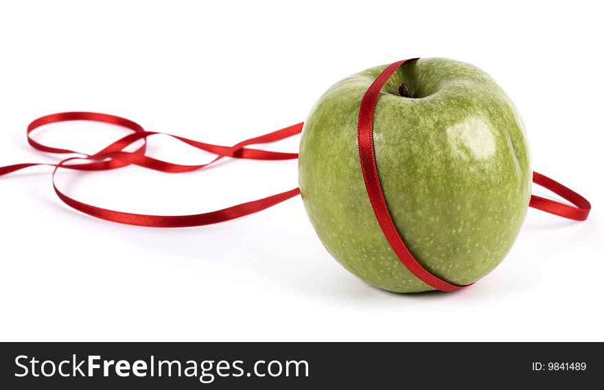 Green apple decorated with red ribbon