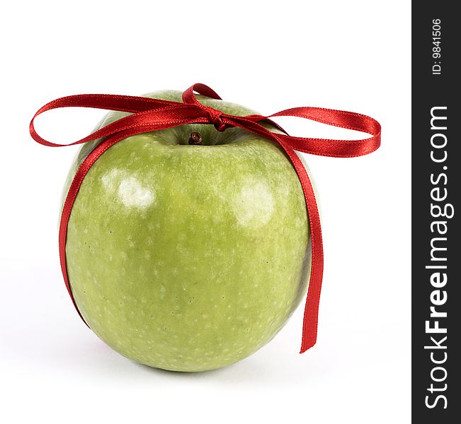 Green apple decorated with red ribbon. Green apple decorated with red ribbon