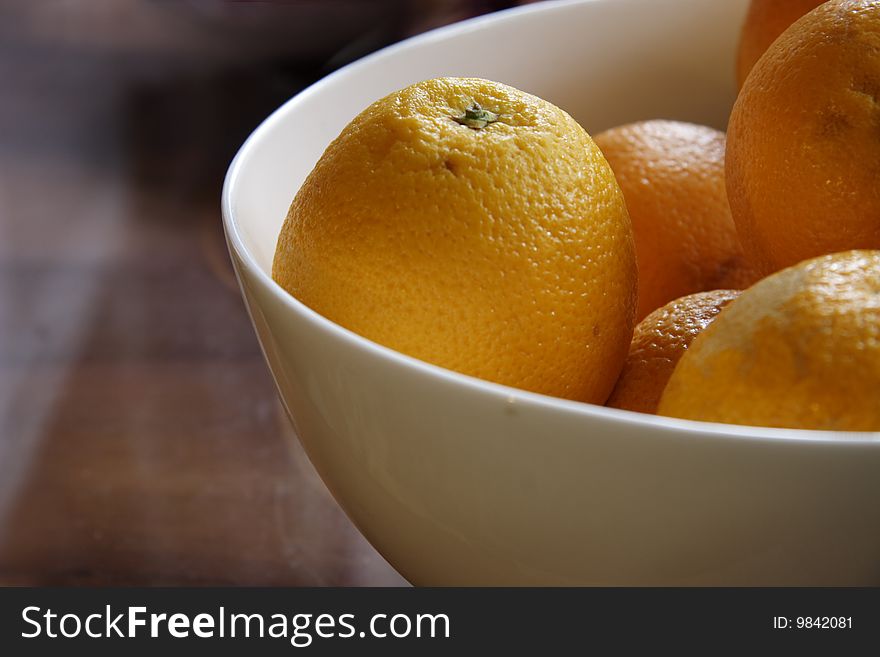 Fresh oranges in a china bowl taken with natural light