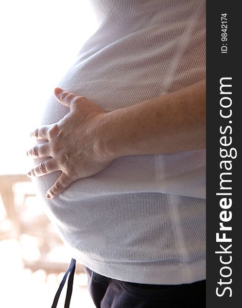 A Pregnant woman expecting a baby with a full belly