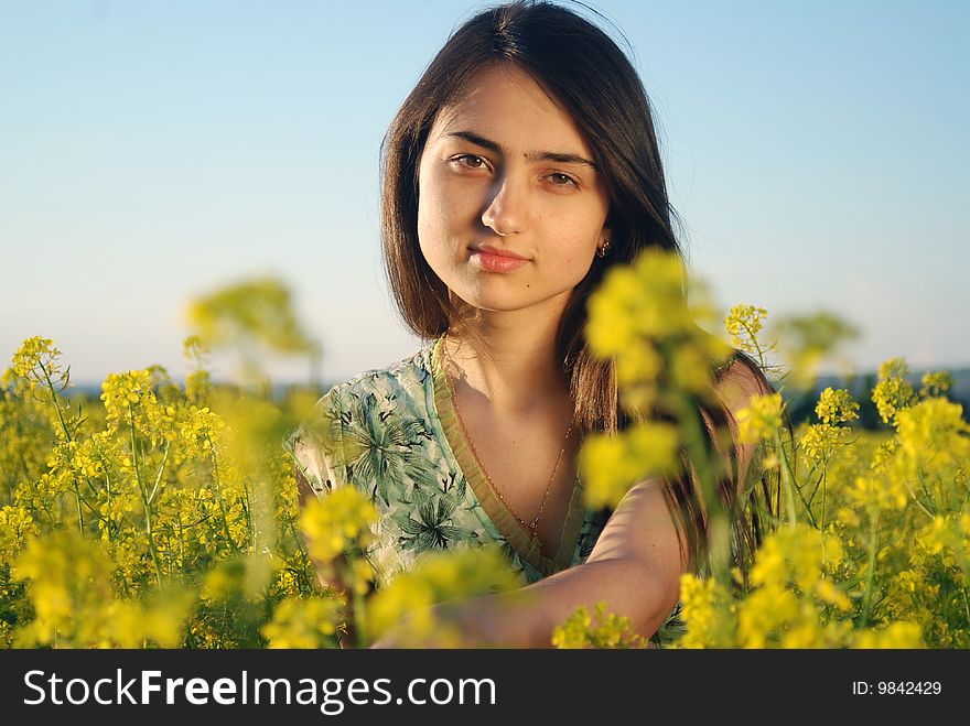 Girl on a yellow canola field