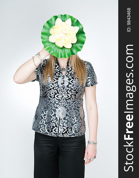 Woman with lotus flower, studio shot