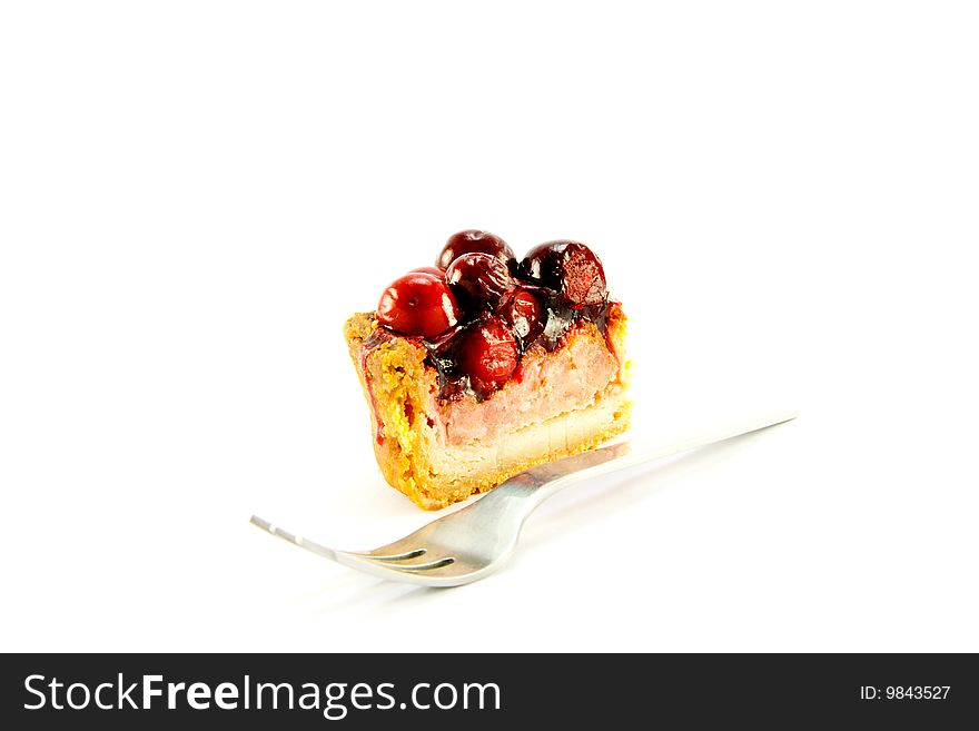Slice of pork pie and a fork with clipping path on a white background. Slice of pork pie and a fork with clipping path on a white background