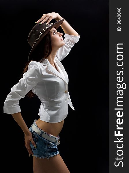 Beautiful woman in shorts and hat shot in studio