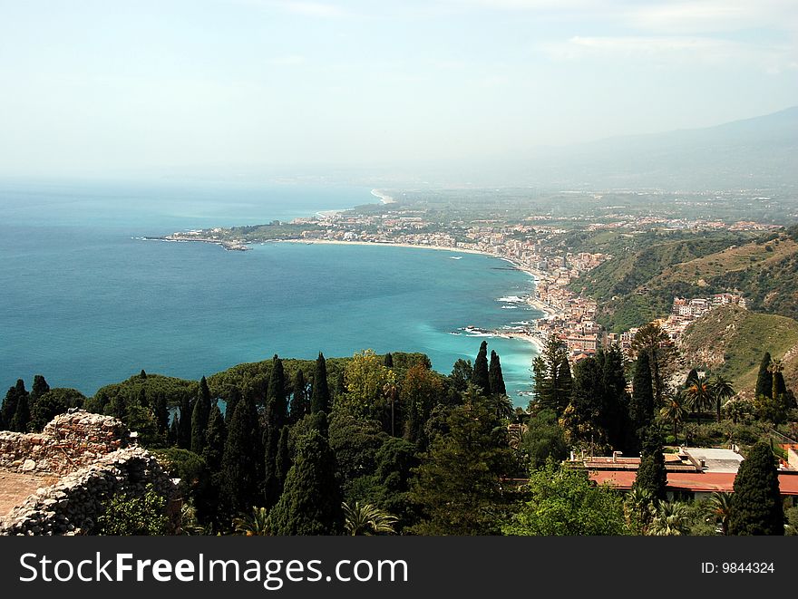 Bay with clear blue water in Taormina, coast of North Sicily, old towns and beautiful sea. Bay with clear blue water in Taormina, coast of North Sicily, old towns and beautiful sea.