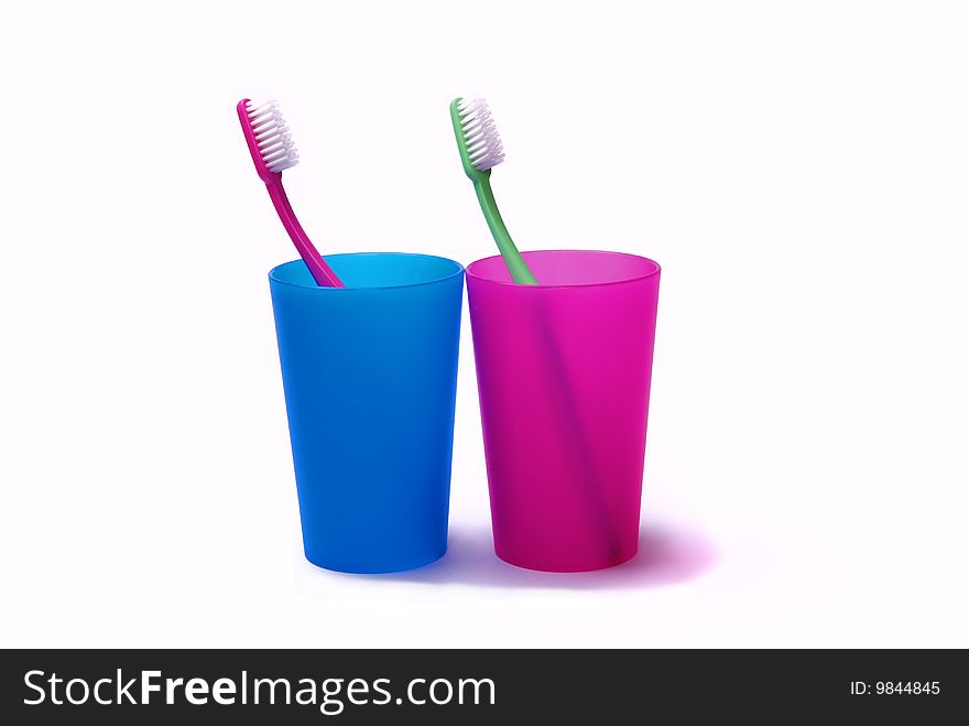Toothbrush in a color holder on white background. Toothbrush in a color holder on white background