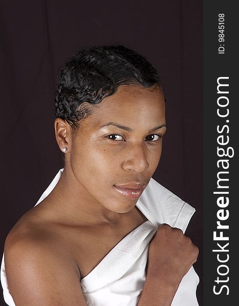 Beautiful black woman wrapped in a sheet over a black background